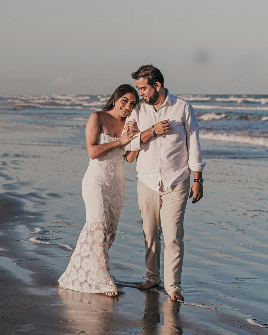 Couple by the beach, waves washing onto shore