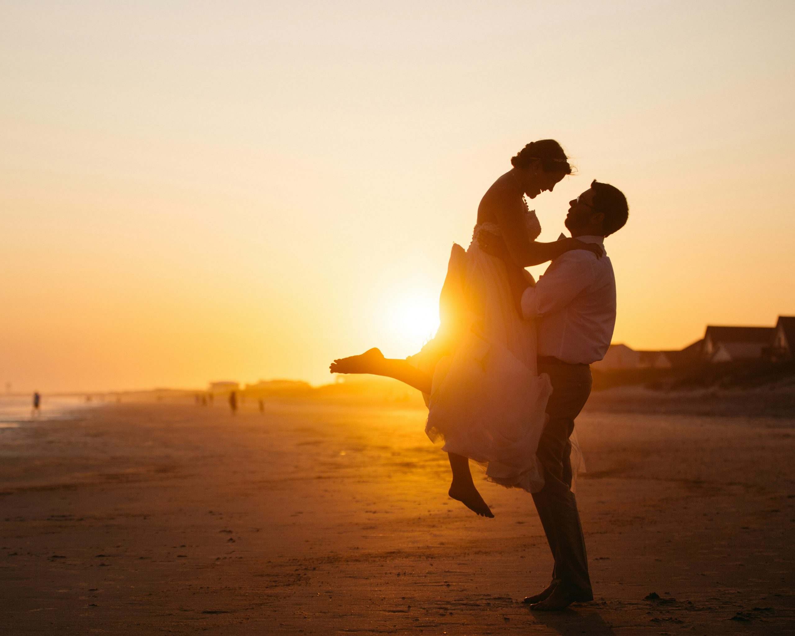 Couple by the beach, waves washing onto shore