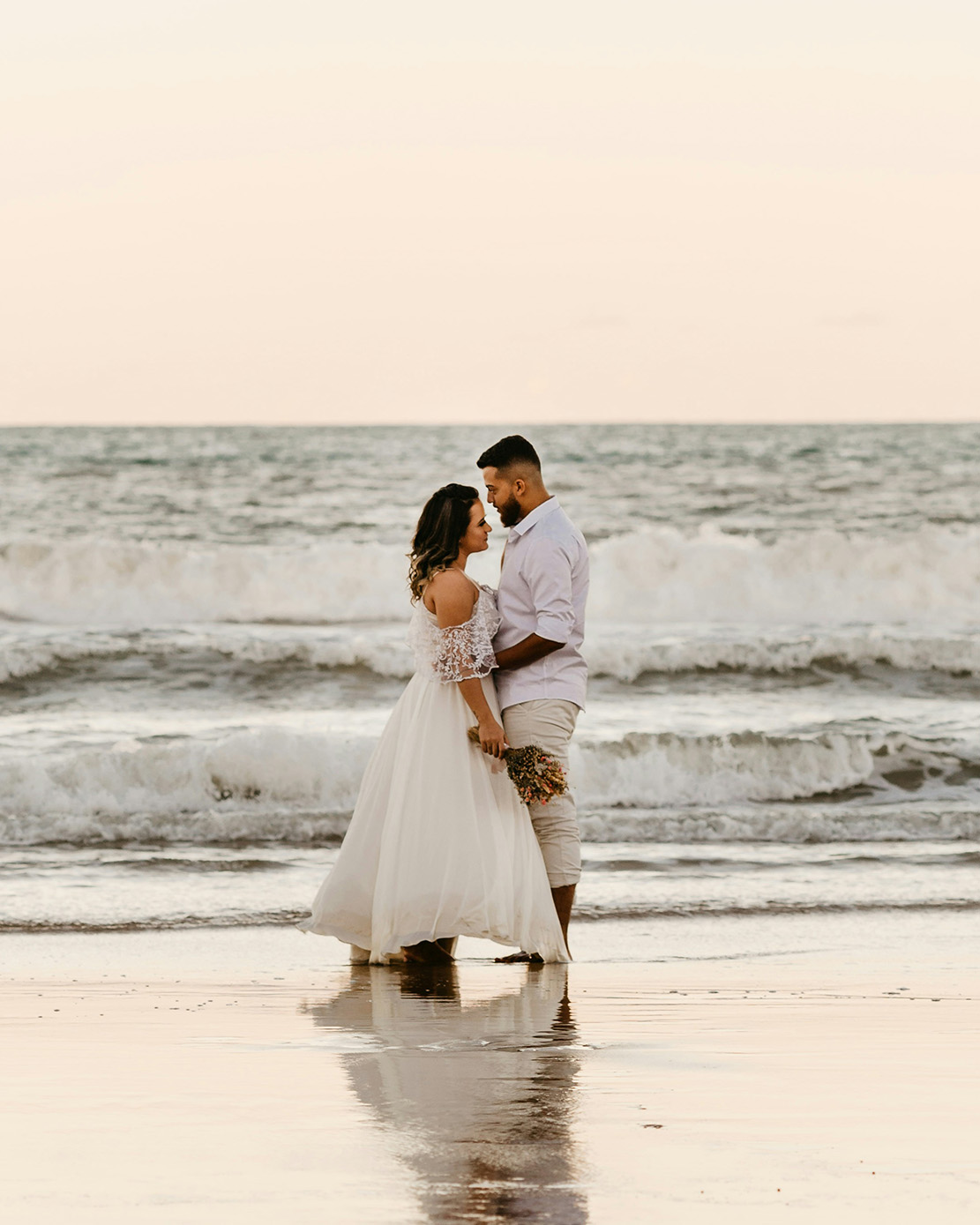 Couple by the beach, waves washing onto shore